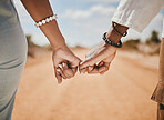 Couple walking, promise and hook fingers for support, trust and love in nature outdoors. Closeup man, woman and connect pinky hands in hope, respect and commitment link of save the date relationship