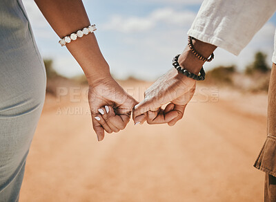 Buy stock photo Couple walking, promise and hook fingers for support, trust and love in nature outdoors. Closeup man, woman and connect pinky hands in hope, respect and commitment link of save the date relationship