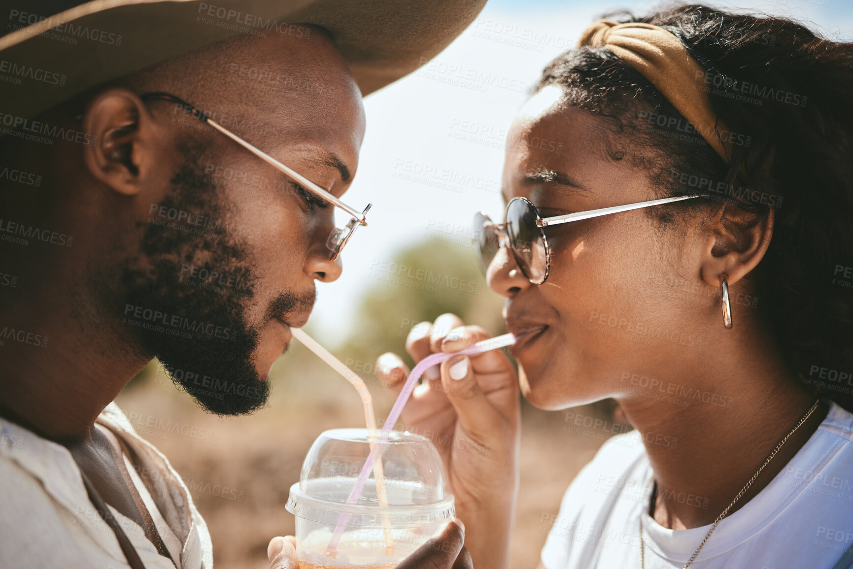 Buy stock photo Outdoor couple sharing straw drink, summer date and sunshine vacation together in Brazil. Young black people face, love and happiness to share drinking romance, relax and holiday fun in garden park