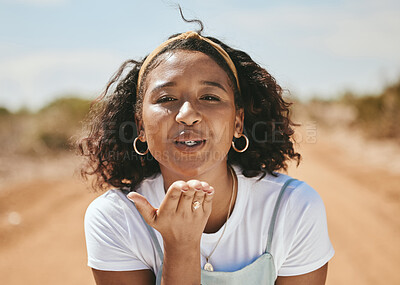 Buy stock photo Happy woman, blowing kiss and portrait for love emoji, relax and flirting outdoors in Colombia. Young, smile and freedom gen z girl with expression of hand kisses, joy and summer happiness in nature