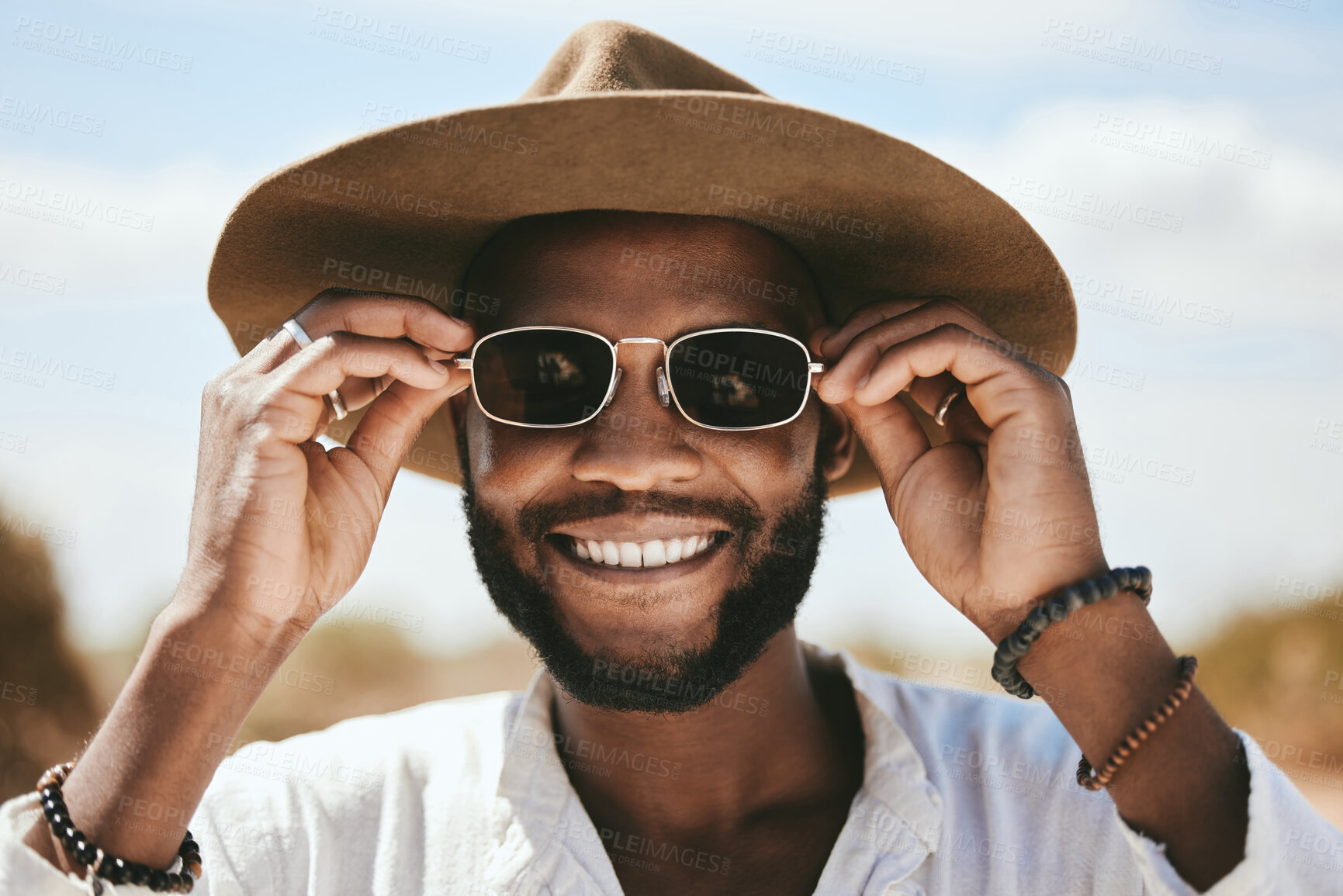 Buy stock photo Vision, style or fashion sunglasses for black man with designer, trend or cool optometry eye care. Zoom, smile or happy face of tourist, model or student on safari travel in Kenya nature environment