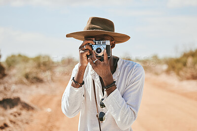 Buy stock photo Travel, photographer and man in a desert in Australia, taking photograph of nature, beauty and earth. Countryside, photography and black man on discovery journey, traveling and enjoying the view