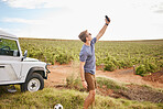 Phone selfie, travel and car road trip nature of a man using a mobile outdoor on a drive break. Countryside, summer vacation and person using technology near a agriculture farm and motor transport