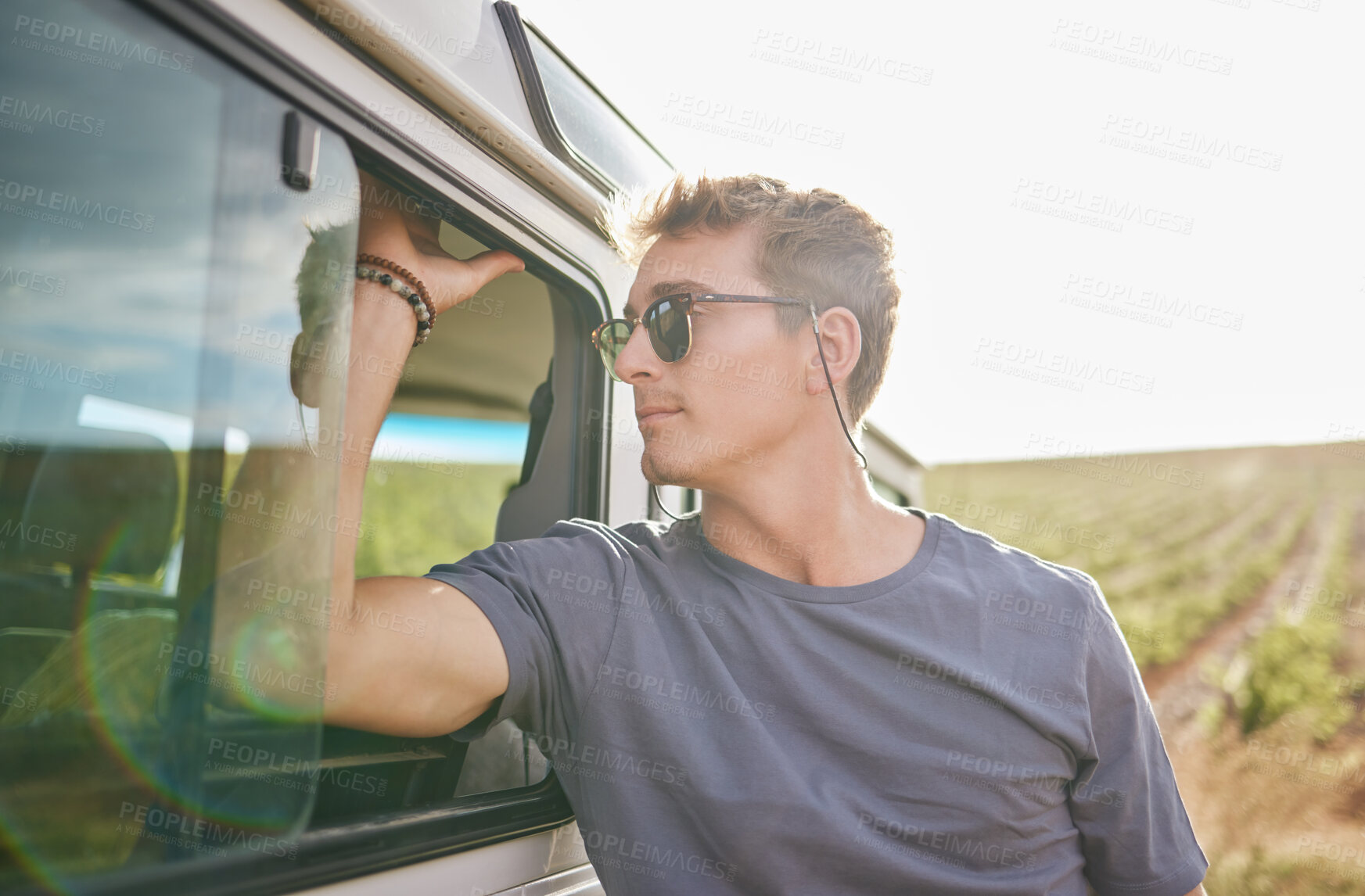 Buy stock photo Travel, adventure and man by his car in the countryside while on a roadtrip during summer vacation. Sunshine, outdoors and young person in nature, relax on journey and traveling lifestyle.