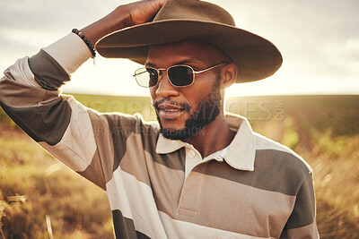 Buy stock photo Farm, agriculture and sustainability with a black man in a field, meadow or grass while farming in nature. Farmer, agricultural and sustainable with a young male working on land for organic produce