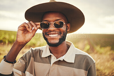 Buy stock photo Black man, sunglasses and farm fashion, holiday vacation and travel with fresh look, cool and relax on road trip. Young male, wear hat and happy smile, adventure and getaway during summer break.