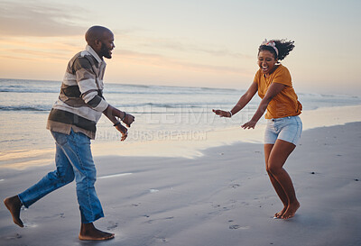 Buy stock photo Love, freedom and couple at a beach at sunset, laughing and having fun on summer vacation in nature. Relax, sea and black woman and man being playful and joking, enjoying sand and ocean walk together