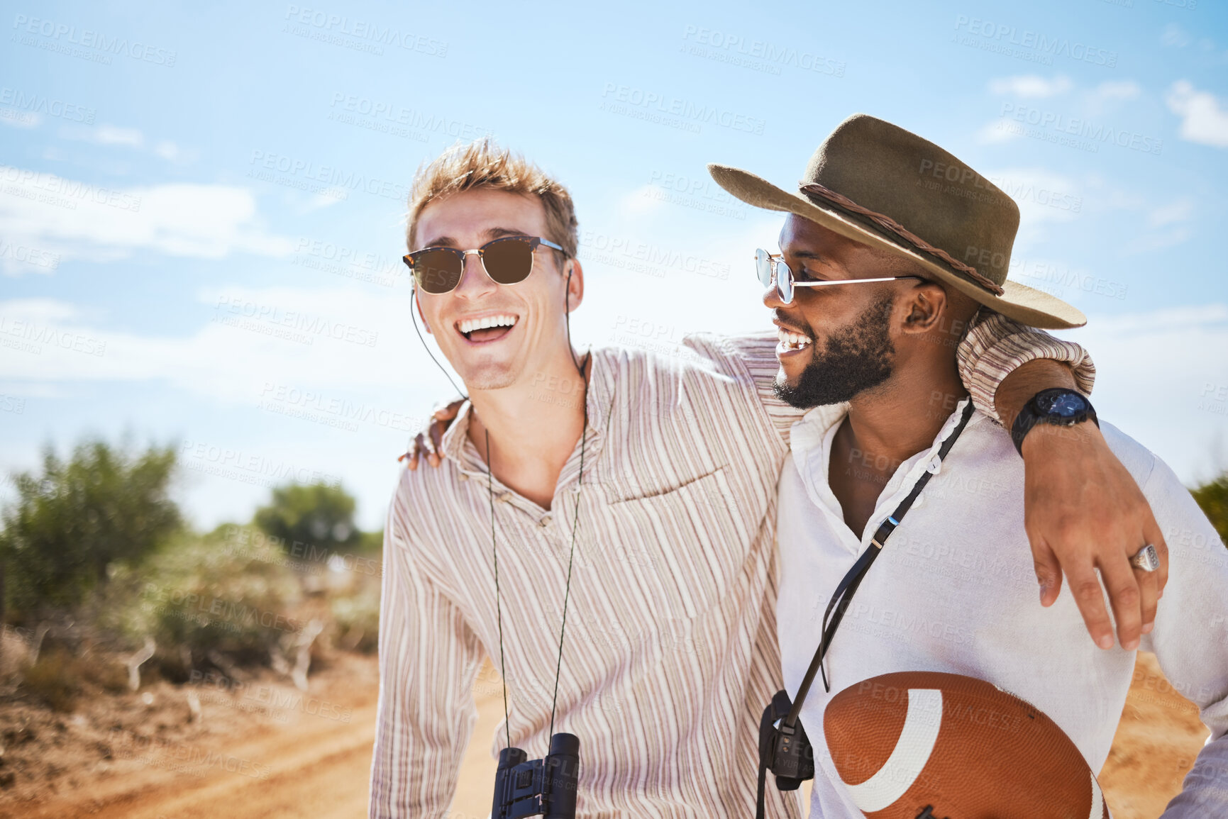 Buy stock photo Nature, adventure and road trip friends in countryside for sports love, funny conversation or social outdoor lifestyle. Diversity, fashion and men couple hug with sunglasses and trendy safari clothes