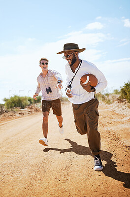 Buy stock photo Football, friends and playing a game with man friends running on a dirt road or the dessert out in nature during the day. Running, fun and summer sport with a male and friend on a sand footpath