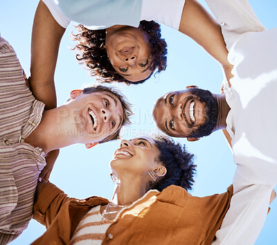 Buy stock photo Friends, teamwork and happy with a man and woman group standing in solidarity outside in a huddle or circle on a blue sky from low. Smile, trust and collaboration with happy people together outside