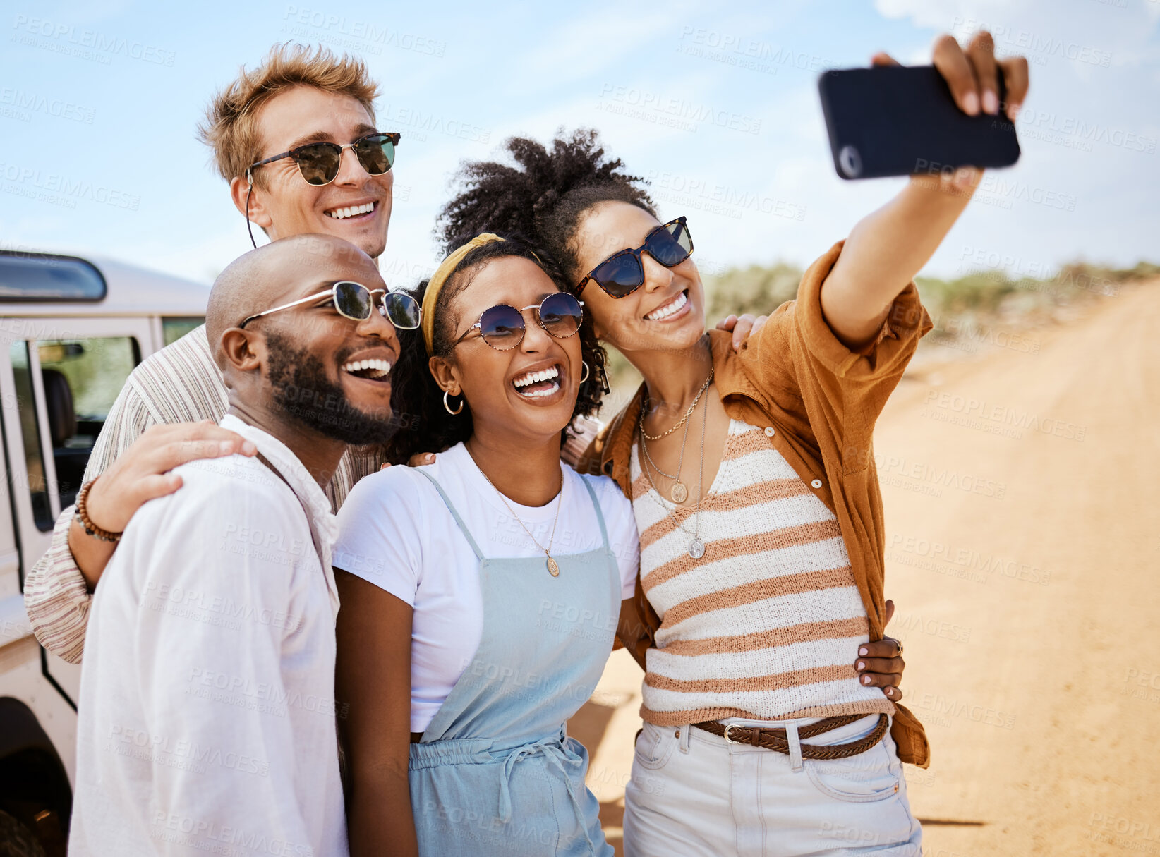 Buy stock photo Safari, travel and friends phone selfie for social media with multiracial people on dirt road. Diverse friendship group enjoying bush holiday together in South Africa with smartphone photograph.