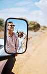 Couple on road trip, smile in car side mirror and happy smile with love on holiday road trip drive in desert of South Africa. Summer vacation in the wild, white man and black woman enjoy the sunshine
