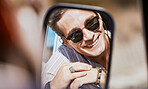 Car mirror reflection, road trip and face of man happy, smile or relax with sunglasses on Sydney Australia tour. Transportation, happiness and young gen z person travel for peace, freedom or wellness