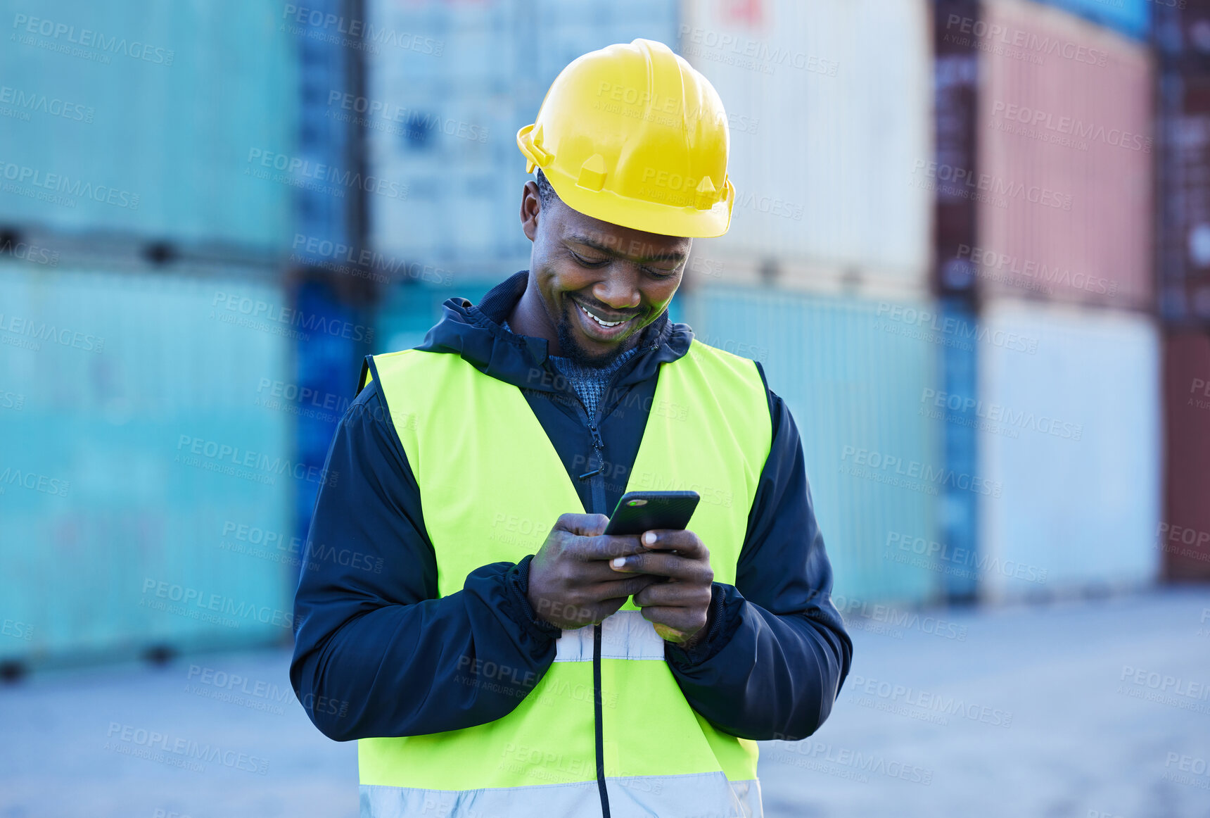 Buy stock photo Social media, logistics and employee working in shipping typing on a mobile app with phone at a port. Happy African warehouse man reading an email or communication on a smartphone at industrial site