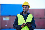 Tablet, black man and cargo planning logistics for shipping company, shipyard and container storage while confident. Business man, hard hat and strategy for freight import or export for supply chain.