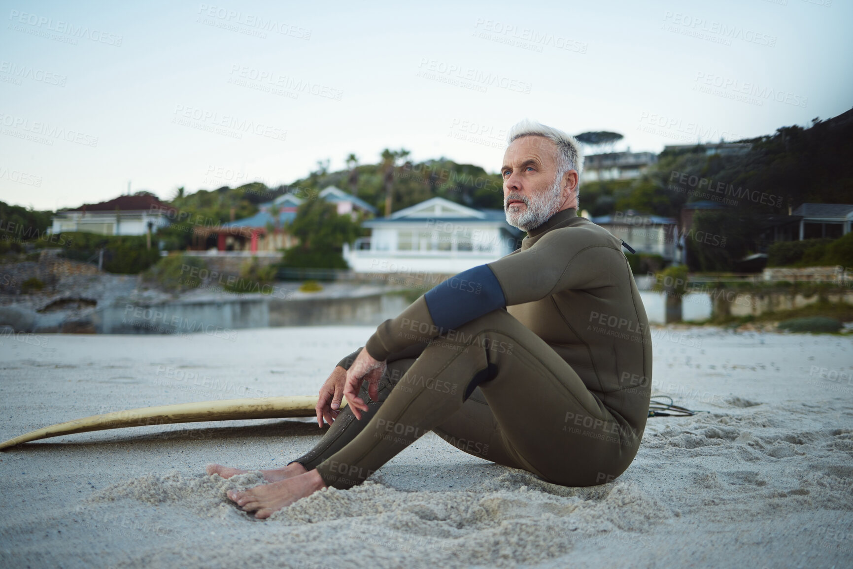 Buy stock photo Thinking, relax and surfer man on the beach for rest, peace and freedom while on tropical holiday. Thoughtful, retirement and senior man sitting on sand in nature by the ocean during surf training.