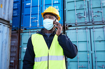 Buy stock photo Logistics worker, container and covid, phone call in shipping port in face mask. Cargo area, smartphone and black man talking on call. Communication, protection and employee safety at freight company