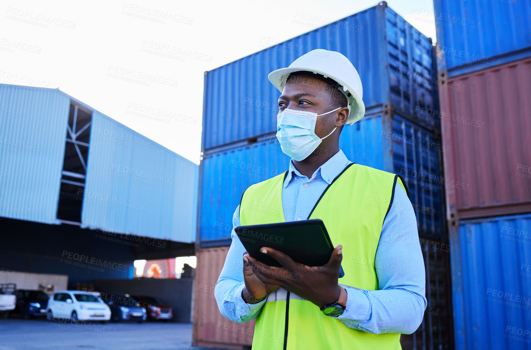 Buy stock photo Man, logistics worker, and covid with a tablet to check inventory in mask with cargo container in background. Black industry employee working, shipping and health and safety at work site.