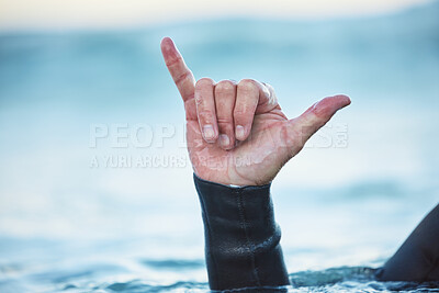 Buy stock photo Shaka, surf and man in ocean with hand sign outdoor in nature while on vacation in Australia. Surfing culture, hang loose gesture and closeup of hands of friendly surfer in water at beach on holiday.