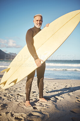 Buy stock photo Surf, sand and sea with a man on the beach for surfing, fitness or exercise while on summer vacation. Sports, workout and training with a mature male surfer outdoor for sport with a surfboard