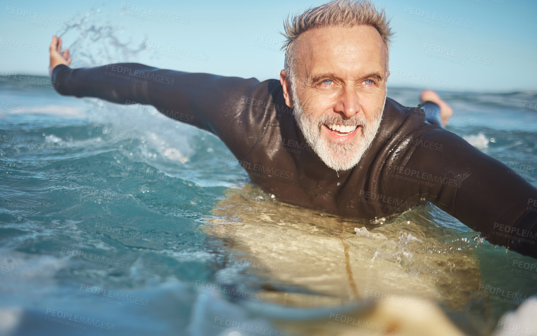 Buy stock photo Beach, water and old man surfer swimming on a summer holiday vacation in retirement with freedom in Bali. Smile, ocean and senior surfing or body boarding enjoying a healthy exercise on sea of Island