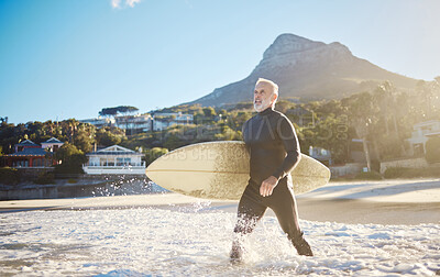 Buy stock photo Beach, surfing and senior man with a surfboard walking in the ocean water for training on vacation. Adventure, exercise and elderly surfer in the sea while on a retirement holiday in Bali Indonesia.