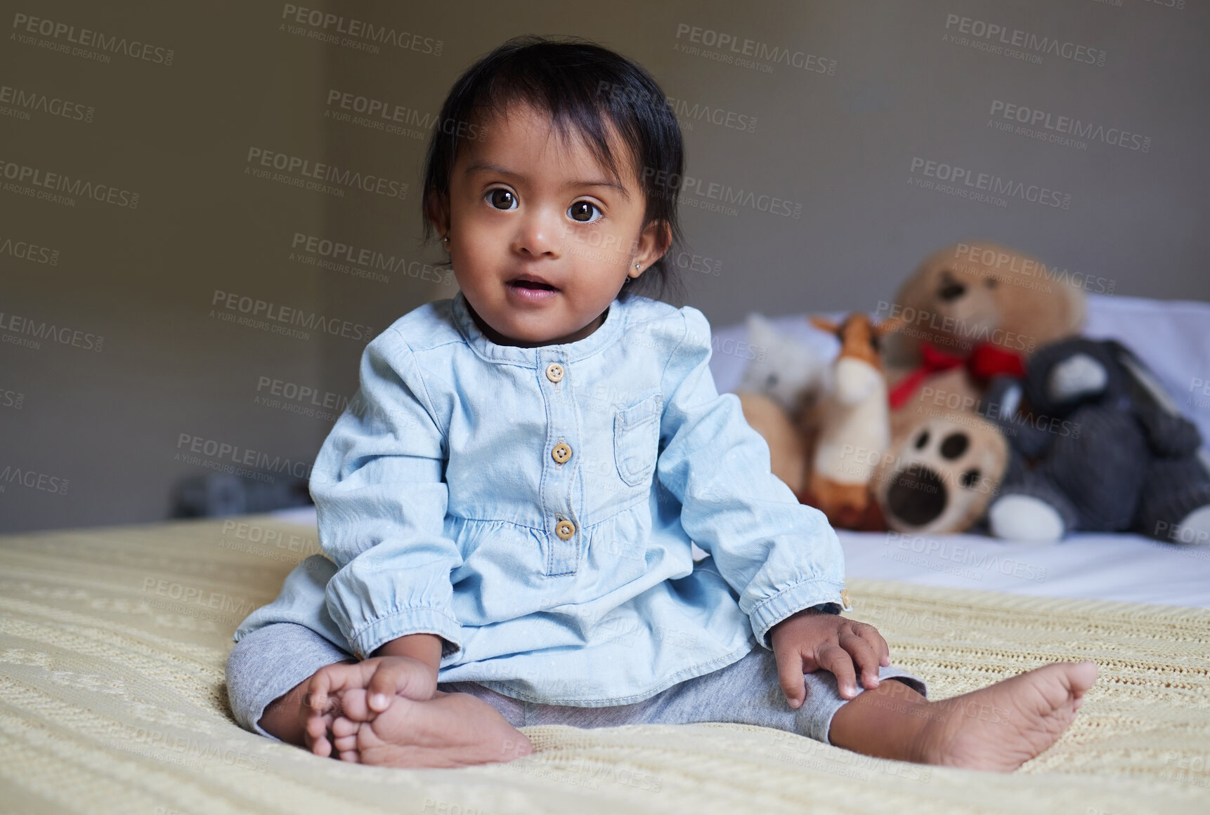 Buy stock photo Baby, cute and innocent with a girl on a bed in her home alone with a teddy bear and stuffed toys in the background. Children, small and pure with a female kid in her bedroom in a house in India