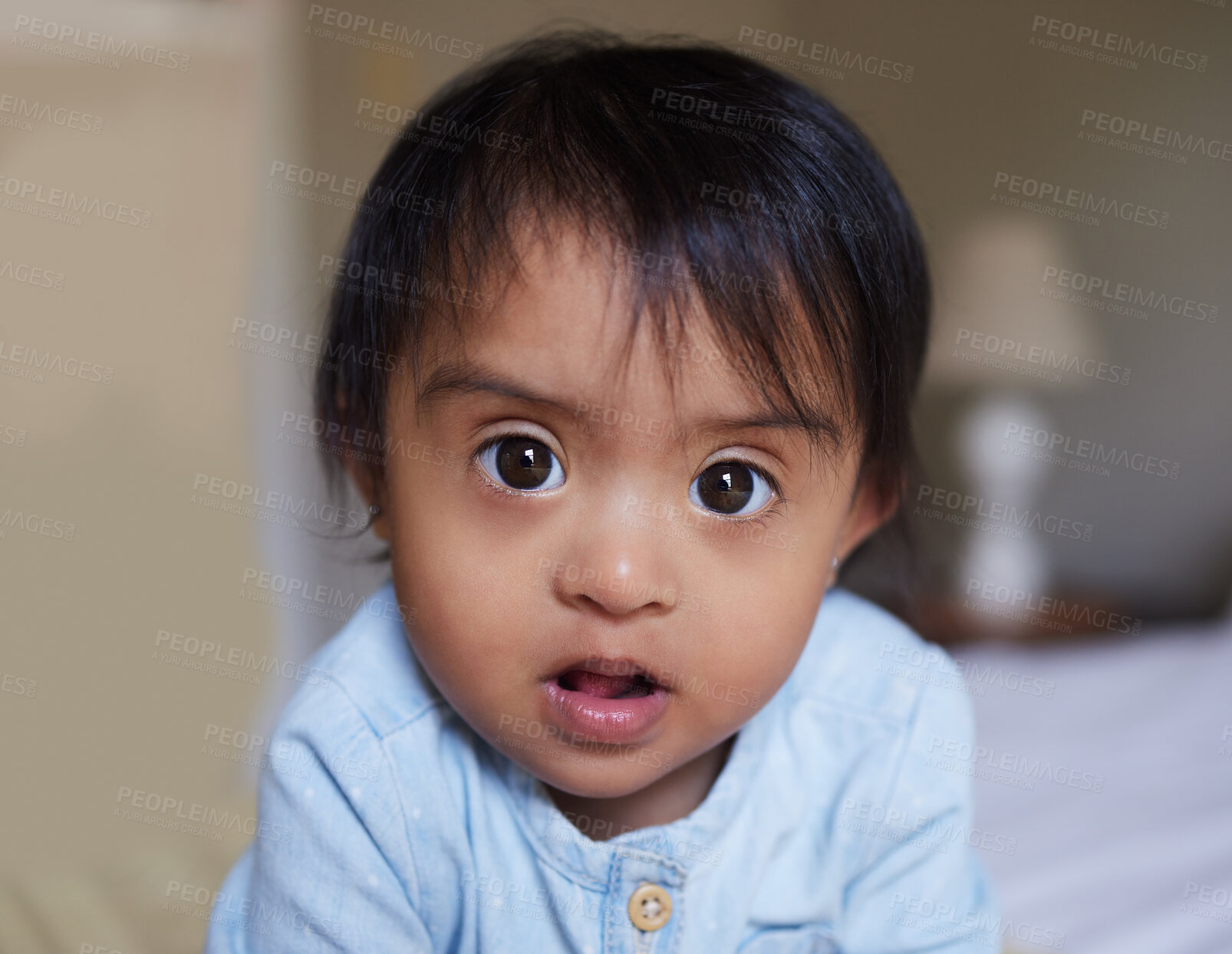 Buy stock photo Face, down syndrome baby and bedroom portrait in home alone, looking innocent and cute. Disability, childhood development and toddler, Indian kid or newborn girl relaxing on bed, curious and adorable