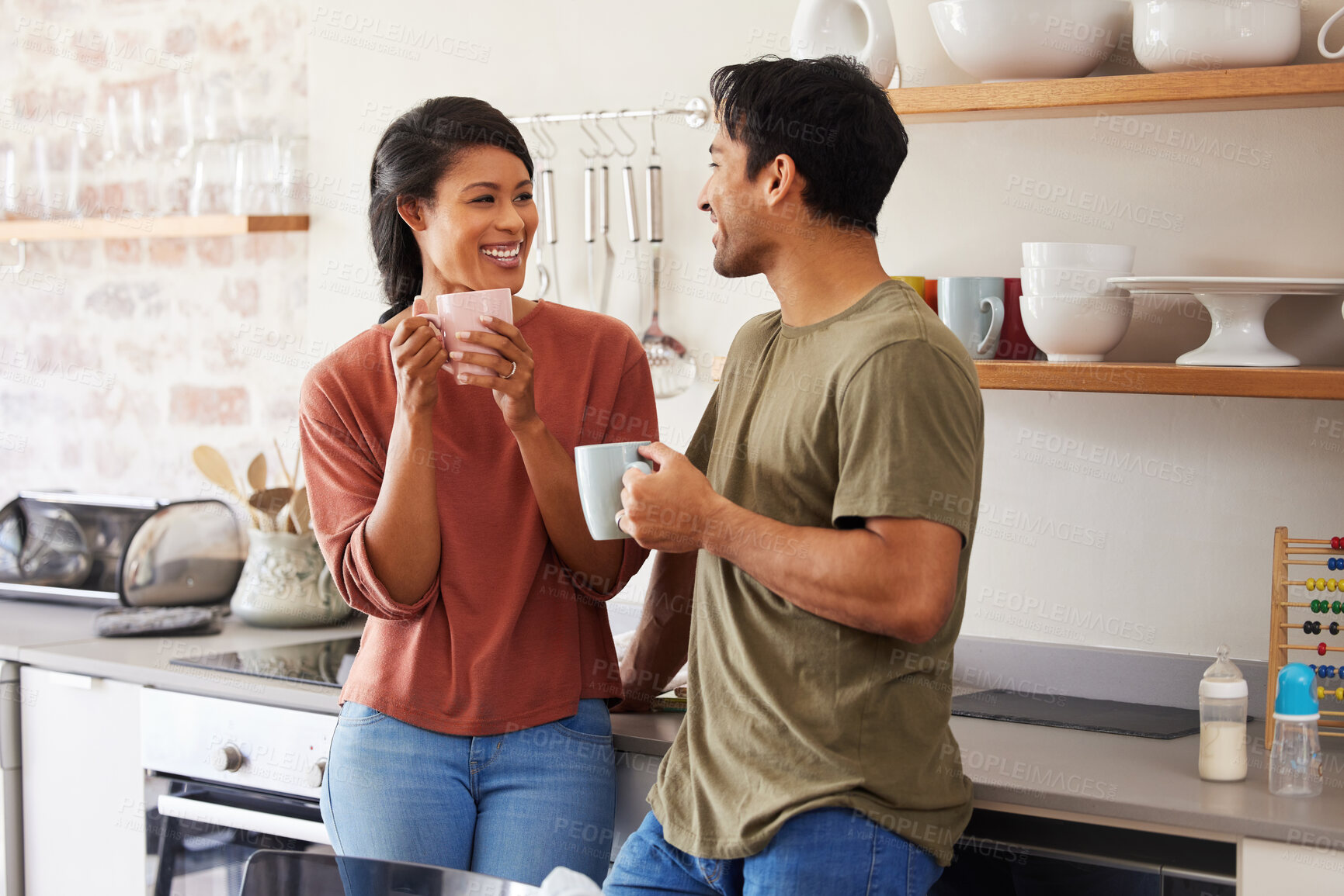 Buy stock photo Coffee break, kitchen and young couple with conversation for breakfast together with love and happiness. Happy interracial people, man and woman or parents talking of real estate apartment and future