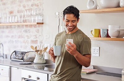 Buy stock photo Phone, coffee and social media with a man in the kitchen of his home in the morning with a smile. Mobile, communication and internet with a young male reading a text message in his house alone