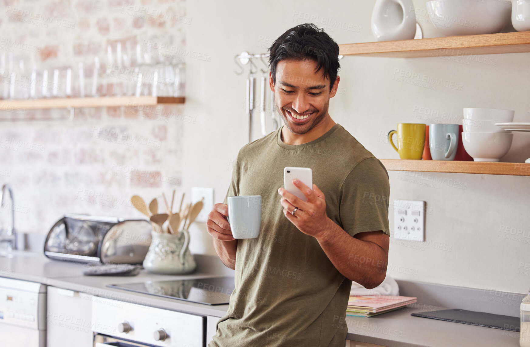 Buy stock photo Phone, coffee and social media with a man in the kitchen of his home in the morning with a smile. Mobile, communication and internet with a young male reading a text message in his house alone