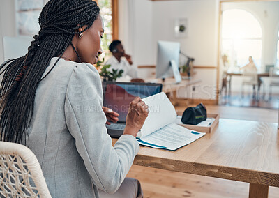 Buy stock photo Paperwork, office and black business woman reading corporate company documents at her desk in the workplace. Professional, young and african leader or manager working on a management strategy report.
