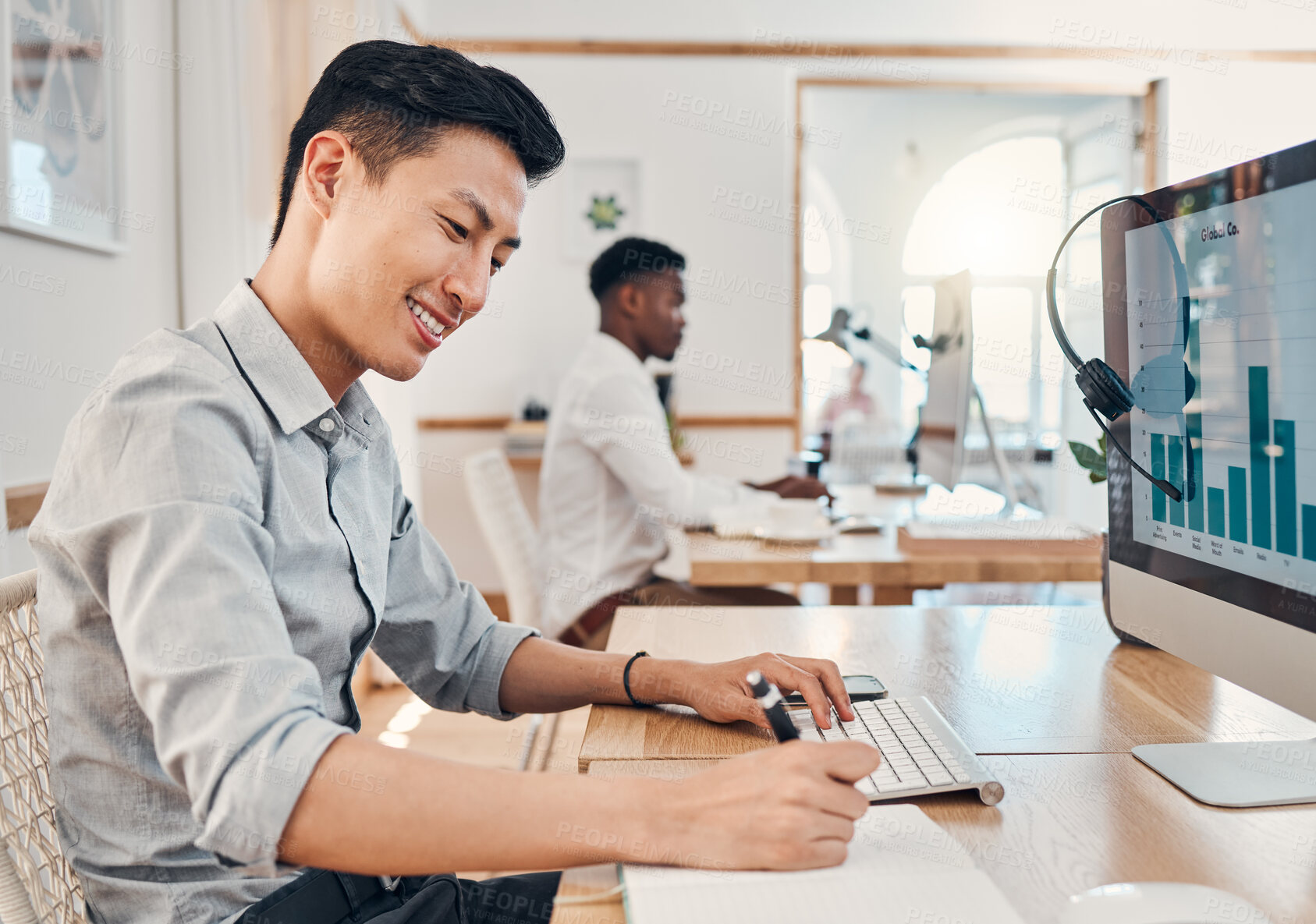 Buy stock photo Call center, telemarketing and crm consultant writing sales report on infographics, Seo data and statistics on computer. Asian man with notebook for finance analytics, profit and performance notes