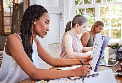 Buy stock photo Black woman with business documents, writing at desk and women working together on audit report at startup. Diversity, teamwork and success, reading small business project proposal and taking notes.