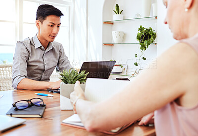 Buy stock photo Man, asian and laptop at work in office with woman coworking in marketing, web design or advertising company. Workers, computer and desk with tech for information technology, strategy or planning
