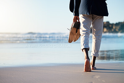 Buy stock photo Walking, beach and mental heath with a business man walking in the sand by the sea or ocean after work. Water, nature and freedom with a male employee taking a walk on the coast during summer