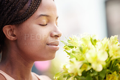 Buy stock photo Black woman, flowers and smelling fragrance happy, satisfied and relax face in spring with blossom. Girl, bouquet and gift smile with scent of petals, leaf and plants in floral design from nature