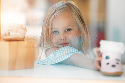 Buy stock photo Girl child, retail shopping for shoes and choosing pink kids winter boots on shelf of childrens fashion shop. Portrait of young customer, toddler at clothes boutique in a mall and buying shoe on sale