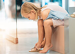 Shopping, little girl and shoes retail at mall for summer sandals decision, choice and purchase. Independent and young female child trying on and choosing fashion footwear purchase at store.