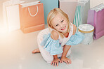 Birthday, gift or present with girl child portrait for fashion, boutique and luxury lifestyle. Kid on floor with shopping bags, young retail customer for children discount, clothes sale marketing 