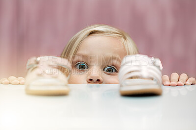 Buy stock photo Girl, shoes and shopping with a child customer deciding between footwear for fashion, style or consumerism. Children, retail and option with a kid looking at a sandle and comparing for her wardrobe