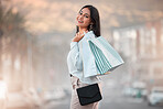 Fashion, style and shopping bags with a woman out on an urban city street enjoying a spending spree. Stylish and rich arab female customer or tourist happy after buying items on discount sale
