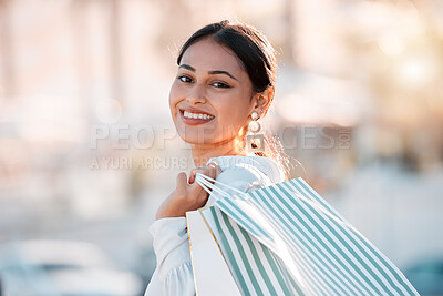 Buy stock photo Woman, retail shopping bag and city travel for discount sales, market and fashion promotion in urban Dubai UAE. Portrait of happy, rich wealth and smile young arab girl customer buying luxury outdoor