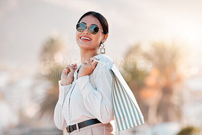 Buy stock photo Fashion, style and shopping bags with a woman luxury sunglasses on an urban city street enjoying travel. Stylish, tourism and rich arab female customer or tourist happy about sale discount purchase