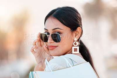 Buy stock photo Woman, fashion and shopping happy with sunglasses on face in city after sale, discount and bag from shop. Girl, beauty and portrait with style, confidence and smile in time at mall, store or boutique