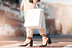Fashion, shopping and woman with bag in the city walking in the street. Retail, shop and shopping bags in female hand crossing road from store, mall and market. Mockup for sale, customer and discount