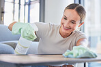 Cleaning, spray and dust with woman and table surface at home for hygiene, domestic service or hospitality with gloves. Smile, housekeeping and cleaner washing furniture counter in living room     