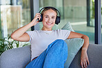 Relax, music and woman listening to radio or podcast on a sofa, cheerful and smile in a living room. Freedom, portrait and streaming by happy, content female enjoying peace and online media audio