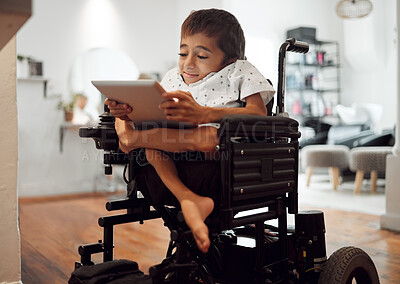 Buy stock photo Wheelchair, disability and child with tablet for learning, video or games in home. Cerebral palsy, boy and disabled use tech on internet, app or web for development of brain, mind and education