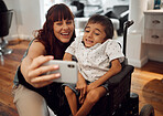 Child, cerebral palsy and happy phone selfie of a mobile disability boy in a wheelchair. Woman or mother smile with a young kid using technology to take a picture together with happiness and care 
